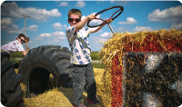 kid pretending to drive a tractor